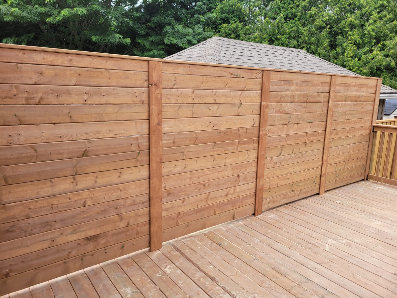 Wood privacy fence in a residential backyard